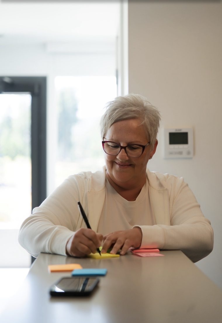 A writer working through the framework on sticky notes
