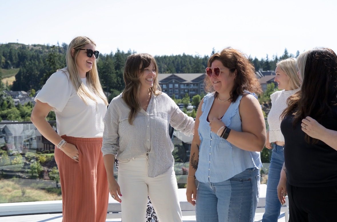 Writers laughing together on the terrace between sessions